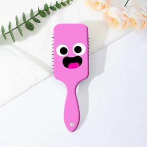 Detail of pink air cushion massage brush with funny big eyes and cartoon expression