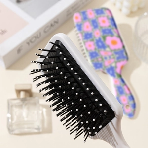 Floral pattern air cushion hair brush with scalp massage bristles and white backplate