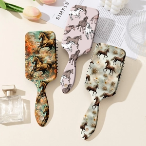 Set of three fashion hairbrushes with horse prints and air cushions on elegant background