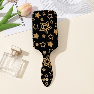 Vue détaillée de la brosse à coussin d'air avec étoiles dorées et trou de suspension pratique