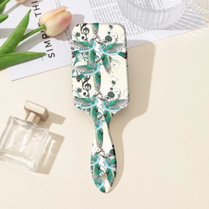 Detail of floral hairbrush with hummingbird print, music notes and ergonomic handle
