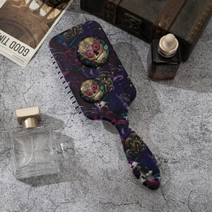 Sugar skull and mushroom pattern air cushion hair brush on a textured stone background