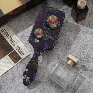 Detail of air cushion hairbrush featuring purple forest print and 3D sugar skull motifs