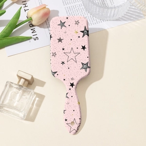 Brosse à cheveux rose à coussin d'air avec motifs d'étoiles dans un décor esthétique