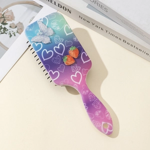Detail of colorful gradient hairbrush with 3D strawberry and butterfly ornaments