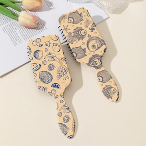 Fruit and ocean print air cushion hair brushes with ergonomic handle on aesthetic background