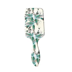 Floral hummingbird print massage cushion hairbrush with musical notes on cream base