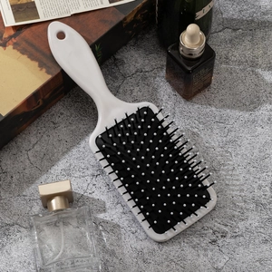 Retro air cushion hairbrush with Day of the Dead skull print for scalp massage