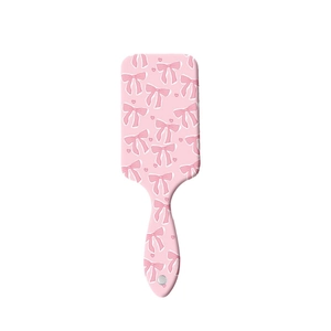 Brosse à cheveux rose avec motif de nœuds et coussin d'air massant contre les nœuds