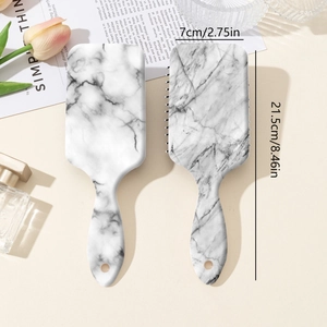 Gray marble print air cushion hairbrush set with detangling pins on a warm beige background