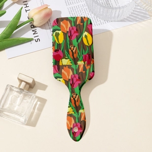 Detail of floral air cushion hairbrush with vintage tulip print on a styled vanity table