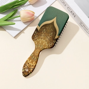 Floral print air cushion paddle brush for scalp massage and detangling on a stylist background