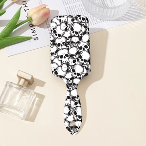 Macro shot of air cushion hairbrush with skull print and stylish vanity accessories