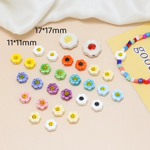 Macro detail of smiley face flower ceramic beads in 11mm and 17mm sizes for DIY jewelry