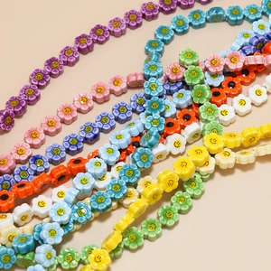 Macro shot of colorful ceramic flower beads with smiling face patterns for DIY jewelry
