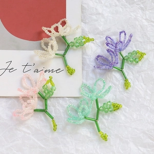 Detail of handcrafted beaded floral pendants in pastel tones for DIY jewelry making