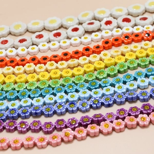 Macro shot of colorful ceramic flower beads with smiley faces for DIY jewelry making