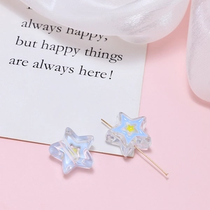 Close-up of star-shaped acrylic beads with yellow center for DIY jewelry making