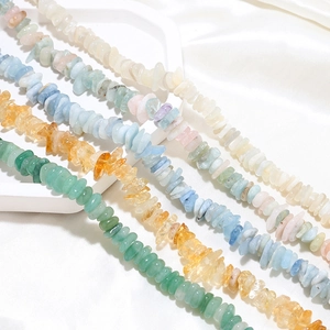 Polished natural crystal stone beads for DIY jewelry making on white satin display