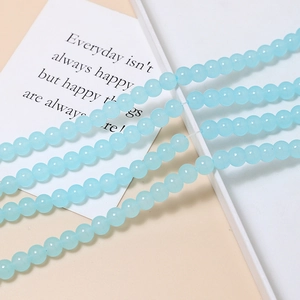 Macro shot of 8mm translucent light blue glass beads for DIY jewelry making accessories