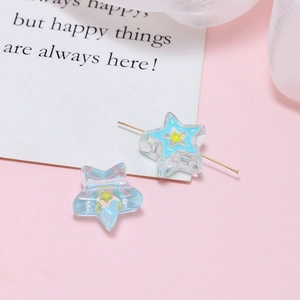 Macro detail of star-shaped resin beads with yellow inner core for DIY jewelry making