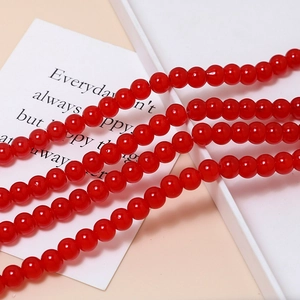 Close-up of 8mm red macaron glass beads with smooth finish for DIY jewelry making