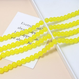 Close-up of 8mm yellow macaron jelly beads for DIY jewelry and bracelet making