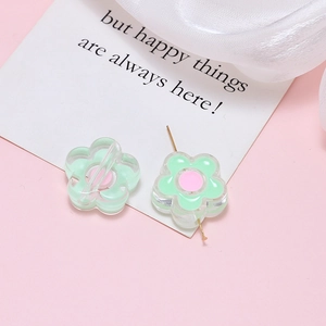 Detailed view of handmade light green acrylic flower beads with pink centers for DIY jewelry