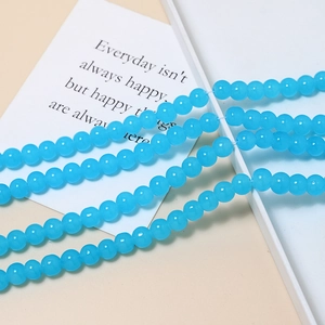 Close-up of 8mm sky blue glass jelly beads for DIY jewelry and handmade bracelets