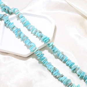 Detailed close-up of light blue irregular natural crystal beads for DIY jewelry making
