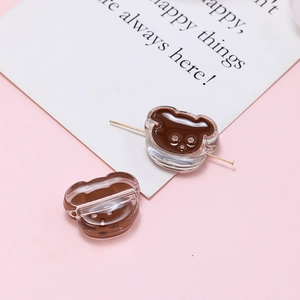 Detailed view of brown acrylic bear-shaped beads for DIY jewelry with pierced structure