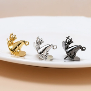 Gold and silver cat wizard hat pendants for DIY jewelry making on white ceramic