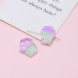 Macro detail of acrylic cupcake beads with needles for DIY jewelry making and crafting