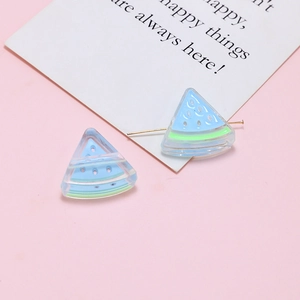 Macro detail of acrylic watermelon charms with metal pins for DIY jewelry making