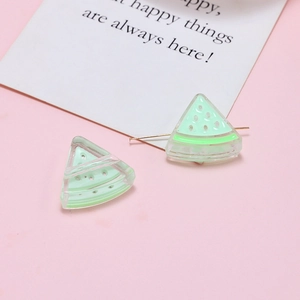 Detail of translucent acrylic watermelon slice charms for DIY jewelry making in green