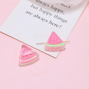 Detailed view of pink and green resin watermelon charms for DIY handmade jewelry crafts