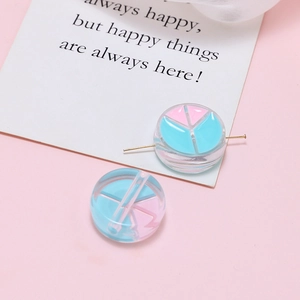 Detail of round acrylic peace sign beads with pink and blue colors for DIY jewelry making