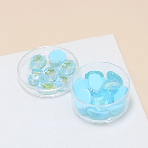 Macro view of light blue iridescent irregular glass beads for DIY jewelry and nail art
