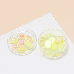 Close-up of aurora yellow crystal water ripple resin charms for DIY jewelry making