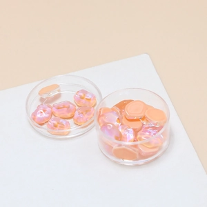 Close-up of iridescent jelly orange crystal resin stones for DIY jewelry and nail art