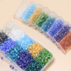 Detail of 4mm colorful frosted glass beads organized in a clear compartment box