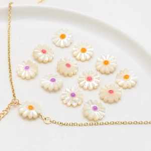 Macro shot of natural mother-of-pearl daisy beads with colorful floral centers