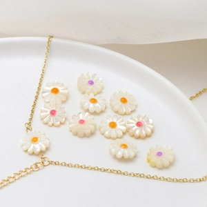 Macro shot of natural shell daisy beads with colorful centers for DIY jewelry making