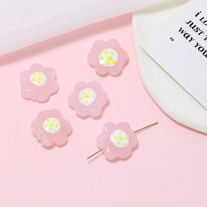 Detailed view of pink floral glass beads with pre-drilled holes for DIY jewelry making