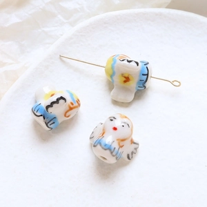 Macro shot of bird-shaped ceramic beads for DIY jewelry making with pre-drilled holes