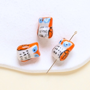 Macro view of owl-shaped ceramic beads showing hole structure for DIY jewelry making