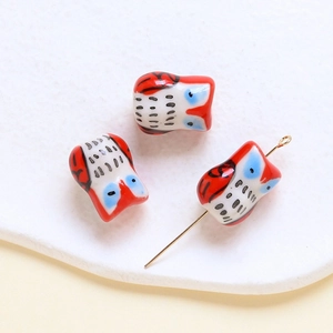 Macro shot of colorful ceramic owl beads for DIY jewelry making and necklaces