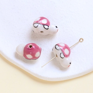Detail of snail ceramic beads with pink polka dots for DIY jewelry making