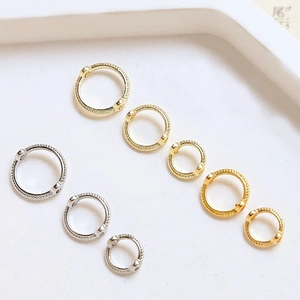Gold and silver twisted hoop earrings set with dual-hole design in three sizes