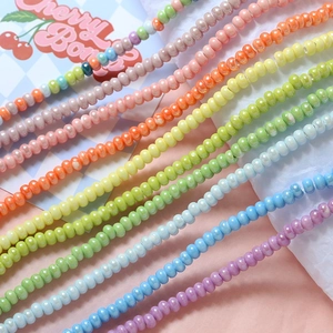 Close-up of pastel macaron ceramic beads in rainbow colors for DIY jewelry making